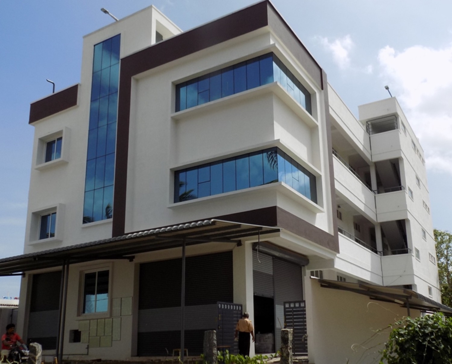 The Fabro Textiles unit in Tirupur seen from the street, a multi-storey building with tinted glass frontage